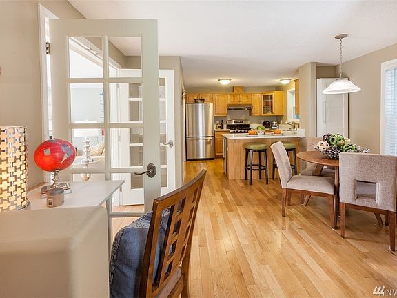 Built-in work desk and white cabinet in dining area. Great room feel with the open French doors! 