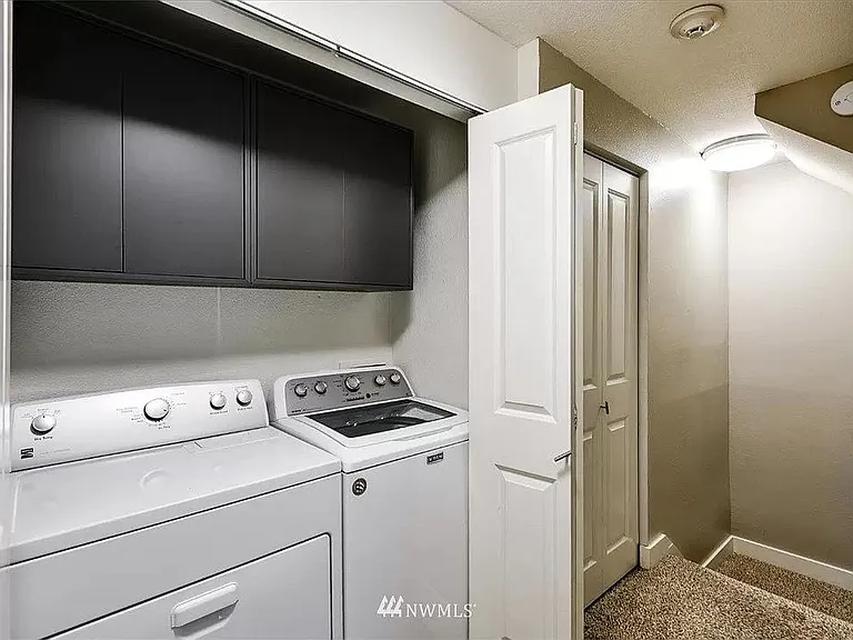 In-unit clothing washer and dryer with plenty of storage space.