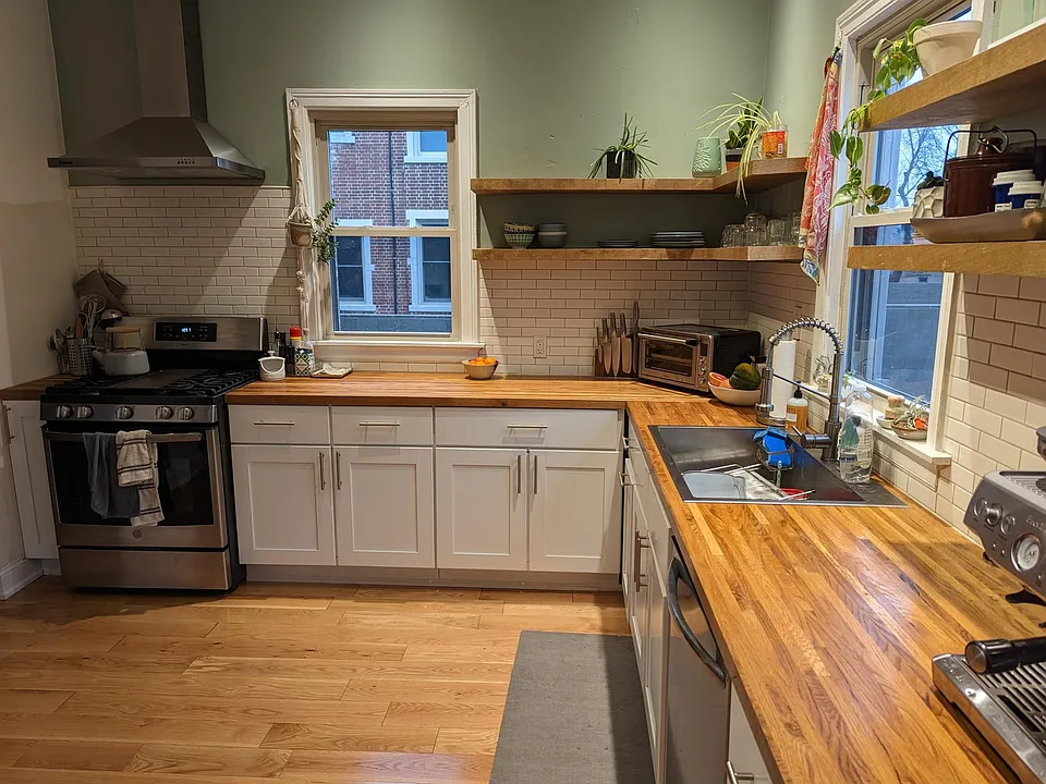 Newly renovated kitchen. Hardwood floor, custom shelves, new appliances, butcherblock countertop.