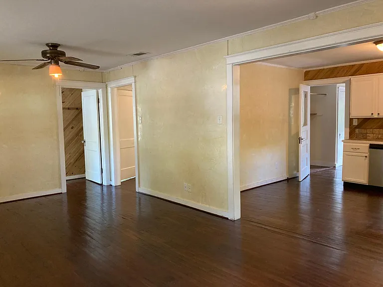 Living room with view of entry to bedroom #1, hall and kitchen