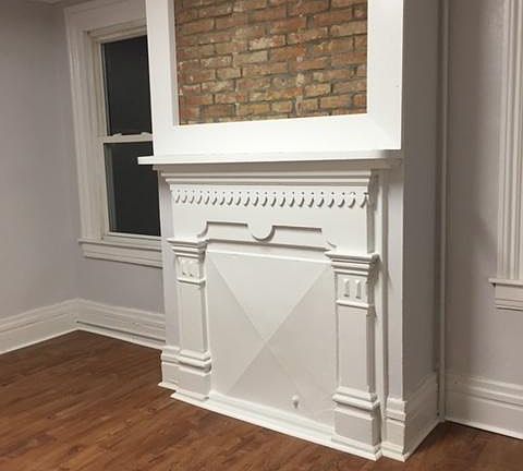 First floor bedroom with original fireplace feature and new floor