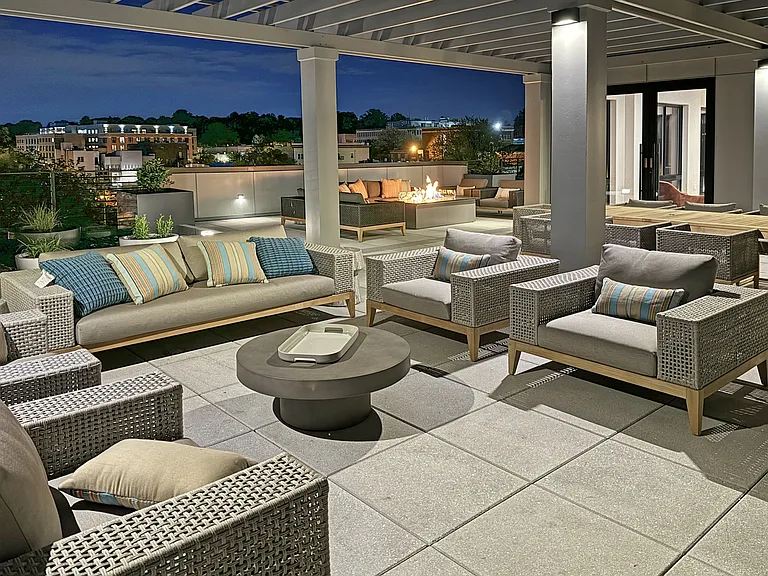 Rooftop deck and clubroom at night.