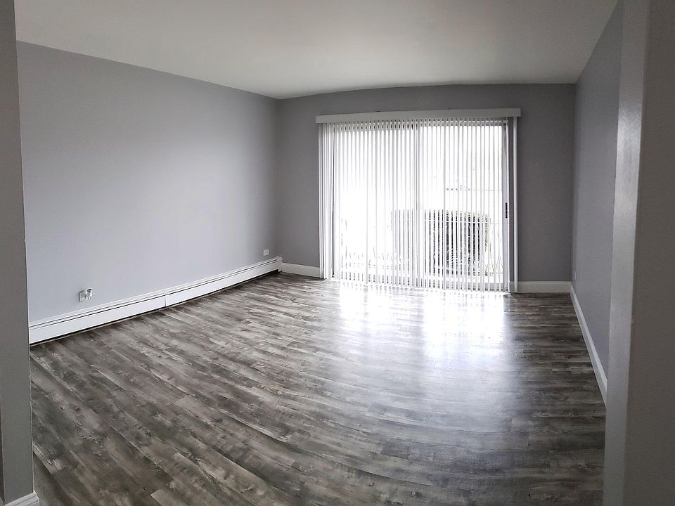 Living Room - Beautiful Vinyl Plank Flooring and Vertical Blinds