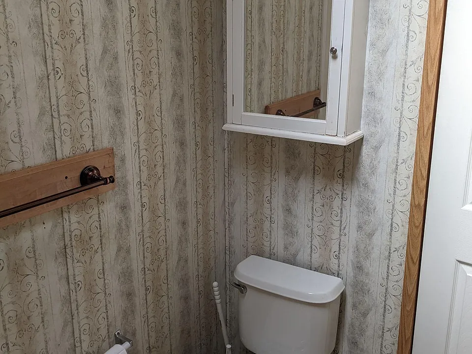Toilet with storage above.