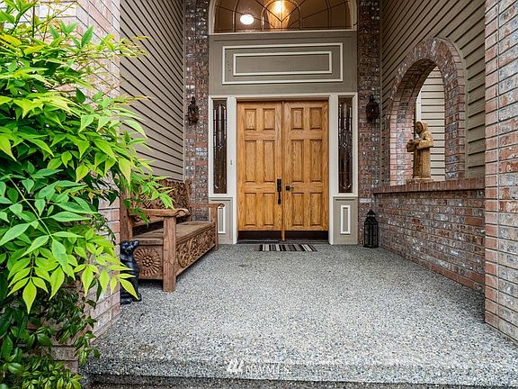 Covered front entry with double doors and leaded glass.