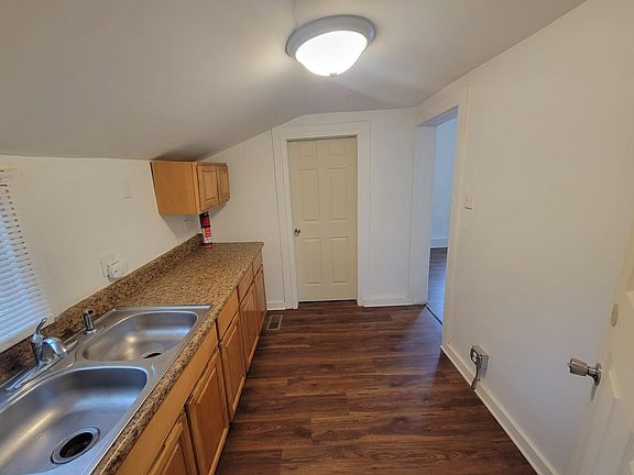 Kitchen, looking toward utility room door; dining room is through doorway on right. New oven and refrigerator not yet installed, and will face sink and cabinets