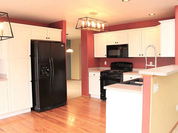 Kitchen boasts new lighting kitchen sink, faucets, garbage disposal. Eat in bay window to left and living room to Right. Dining room access to right of refrigerator.