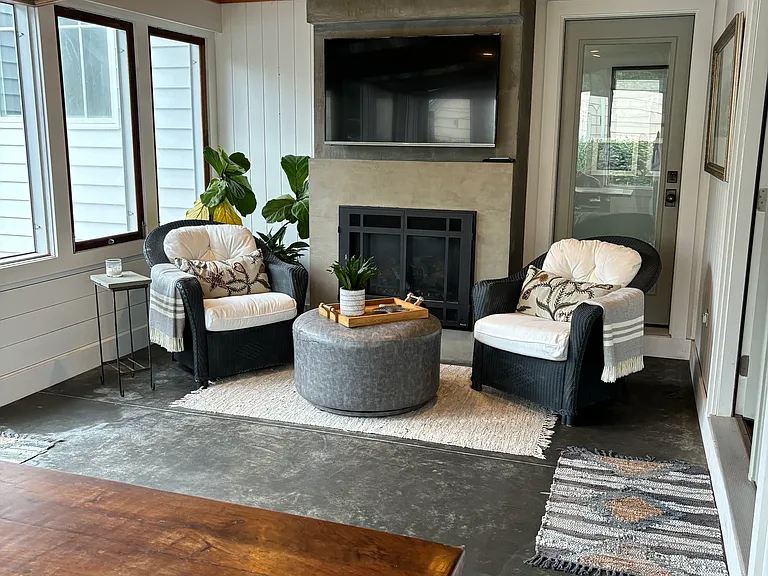 Four season porch with gas fireplace, dining table and drop down windows