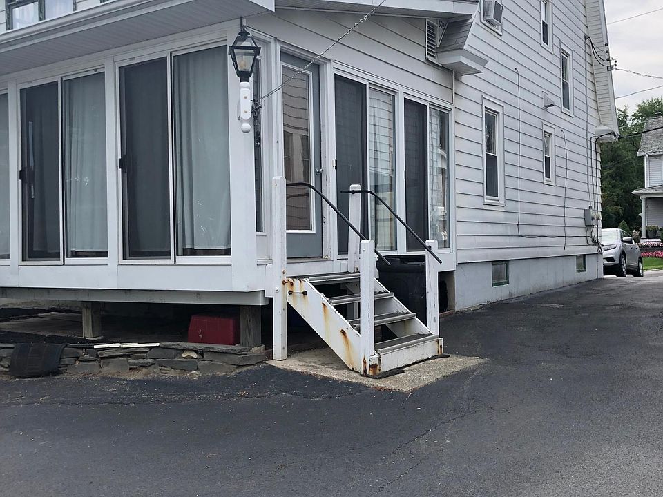 Driveway to back of 1 Highland St. Upstairs back porch windows.