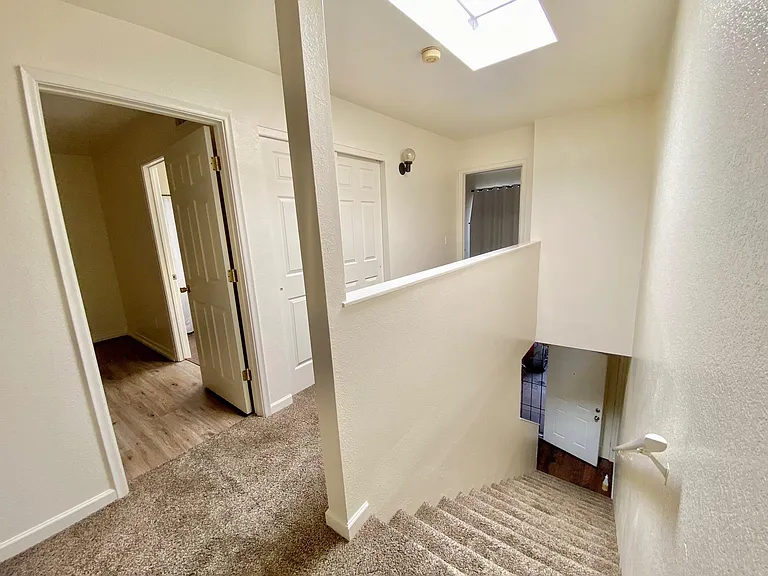 View of master bedroom, second bedroom and hallway storage closet