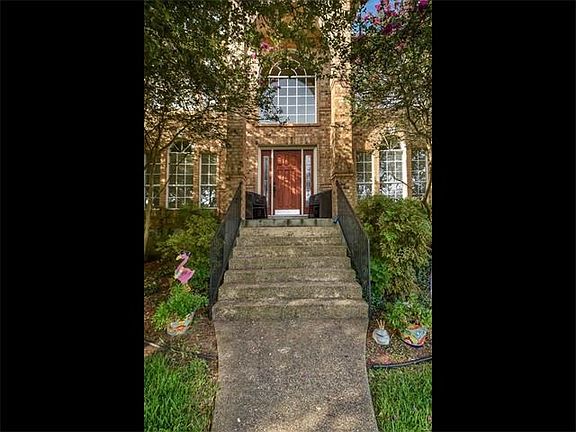 Landscaped entryway provides shade from the hot Texas summers.