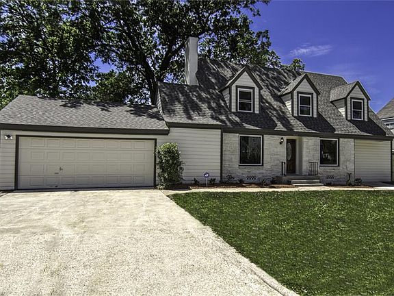 Notice the large windows to invite plenty of natural sunlight into the home.