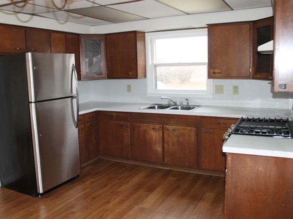 Stainless steel refrigerator and plenty of kitchen cabinets