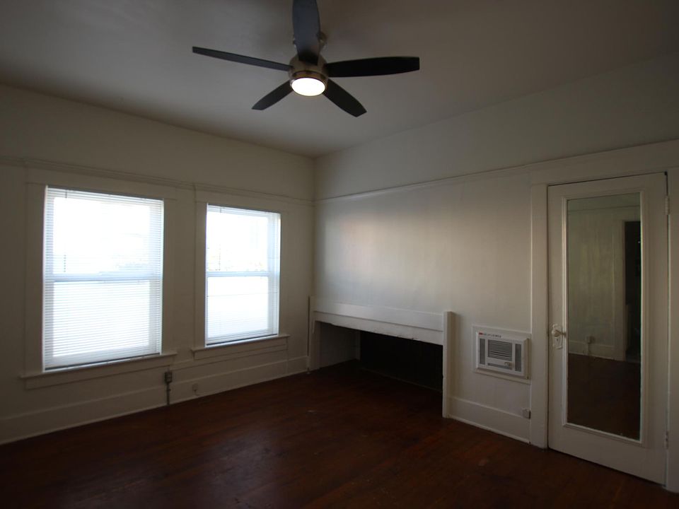 Main room with closet door and mirror.