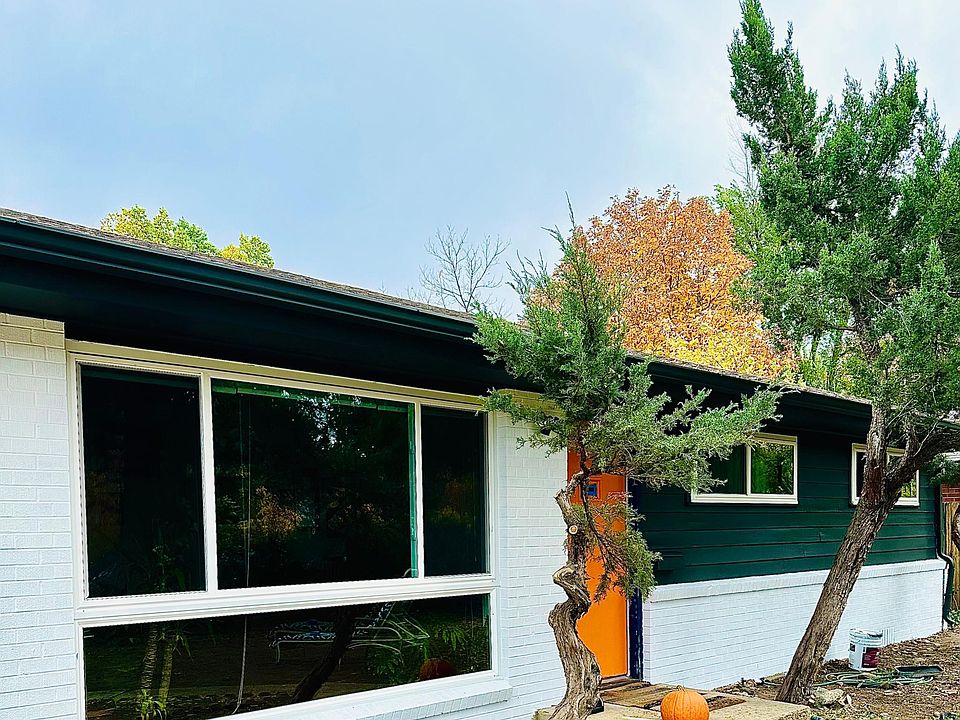 We just finished painting the front black and white with an orange door for pop. The side entrance wooden gate is just to the left of the garage door and house.