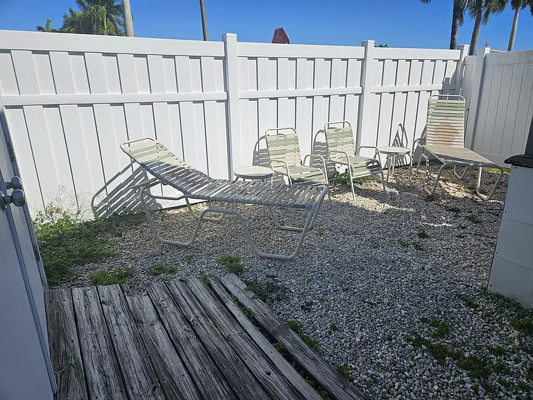 Private back yard with chair and lounge chairs and table - Storage shed which can be used if needed; has bike can be used