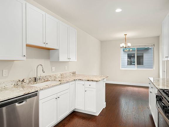 A true chef's delight! This gourmet kitchen features stunning granite countertops, new stainless steel appliances, and a gas range. With ample cabinet space and beautiful hardwood floors, it's perfectly equipped for your next feast!