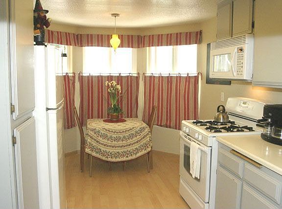 Eat-in kitchen with new white appliances