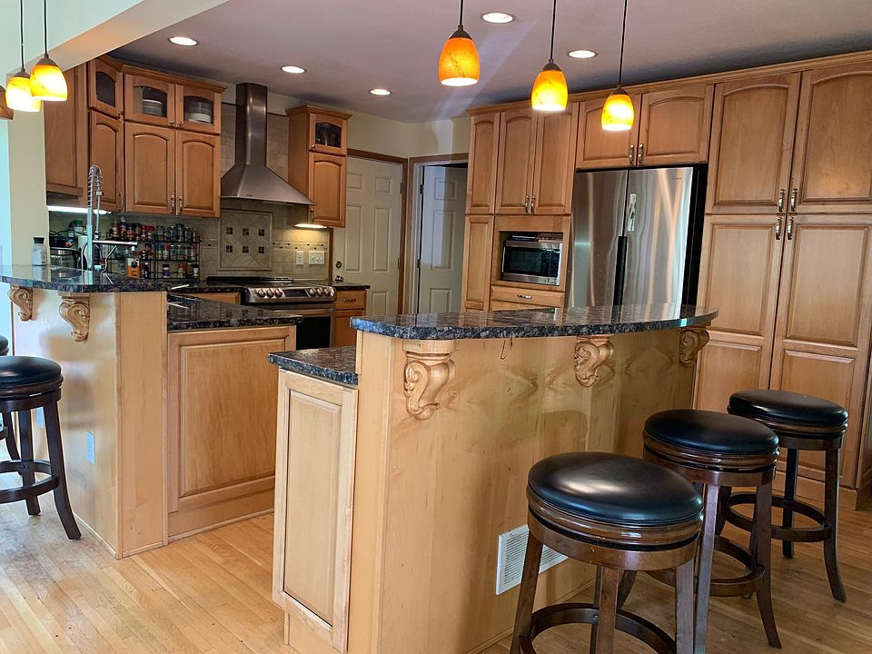 updated kitchen with centered island , stainless steel appliances