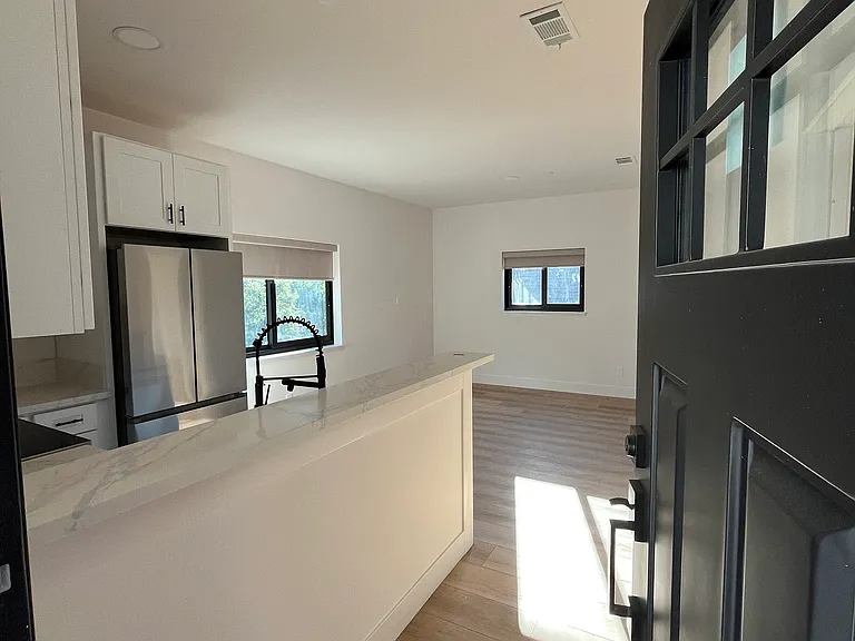 Open concept kitchen and living area. Kitchen comes with a peninsula/breakfast bar.