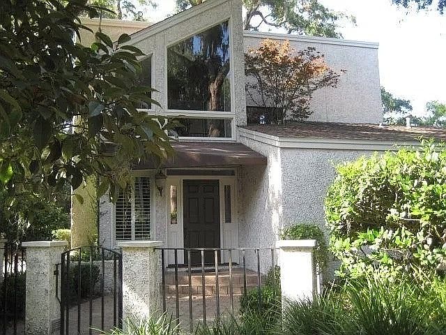 Front of house with view of the Japanese maple tree growing up from our interior atrium.