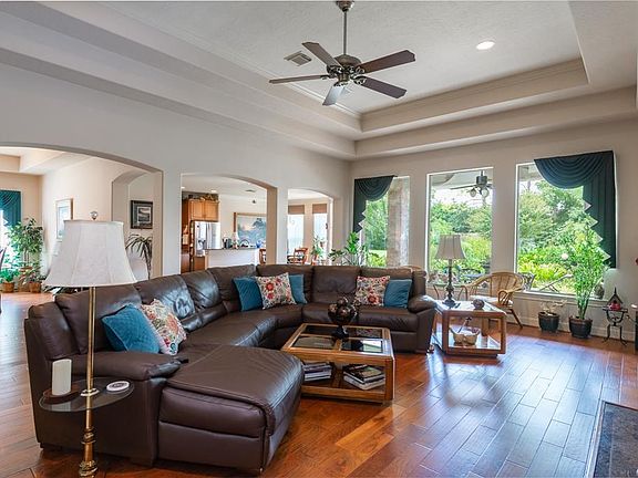 As you approach the family room, your attention is drawn to the wall of windows overlooking your private backyard retreat!