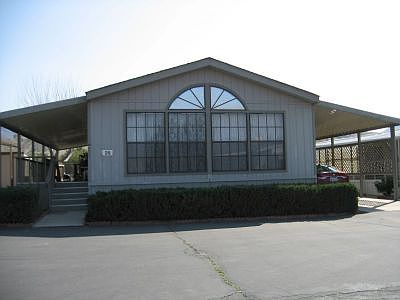 Front with carport and covered deck