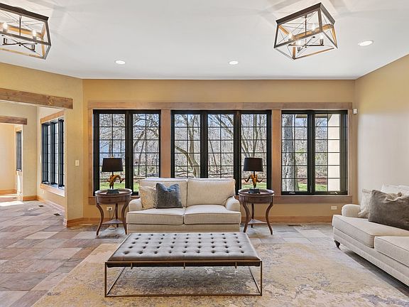 Great room with large black framed windows - naturally frame the views of nature outside.