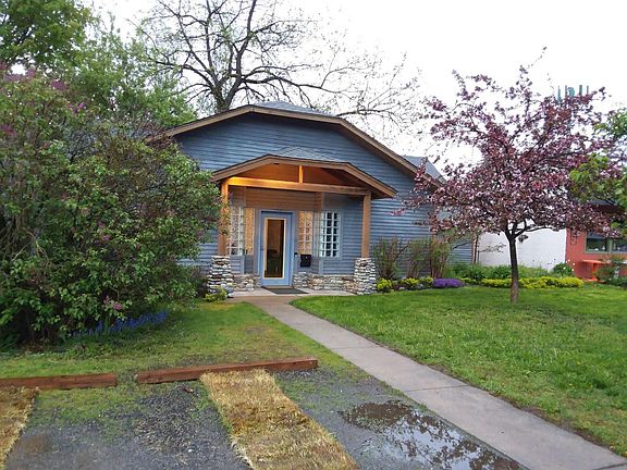Exterior of house....off street parking for 2 vehicles. Landscape is now cut back and privacy fences now up in wildflower garden area....