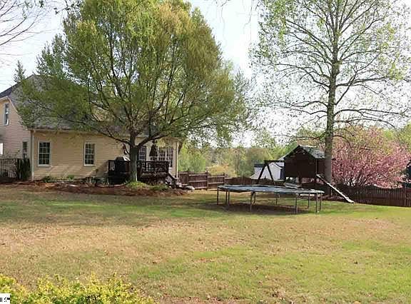 HUGE YARD...Deck has been updated, old playset has been removed and no trampoline.