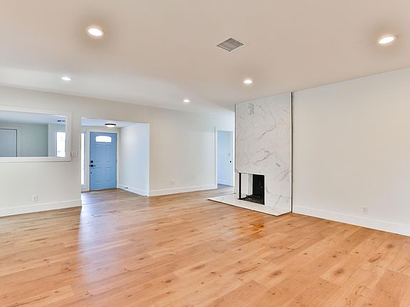 Spacious living room in main house with fire place