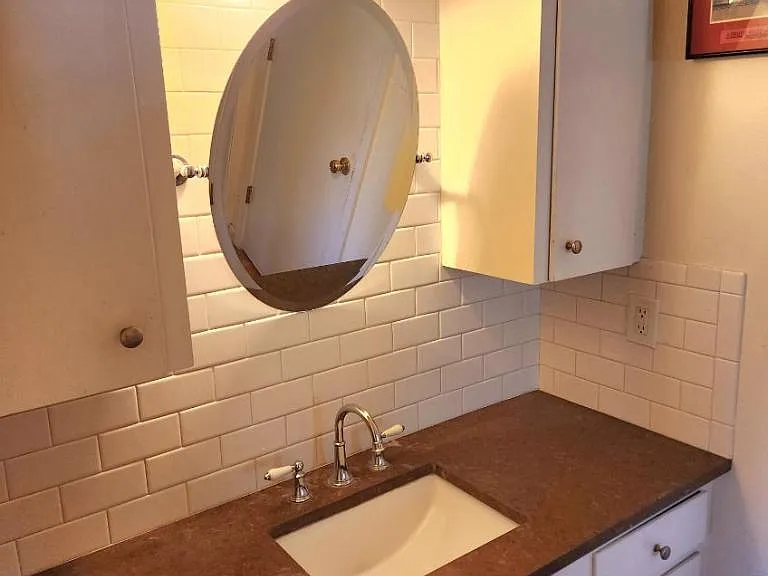 Bath sink area has granite countertops with good counter space