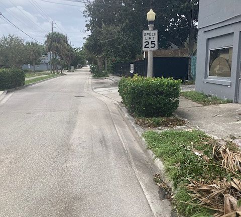 The street view. This property is located behind the gray building on the highest hill