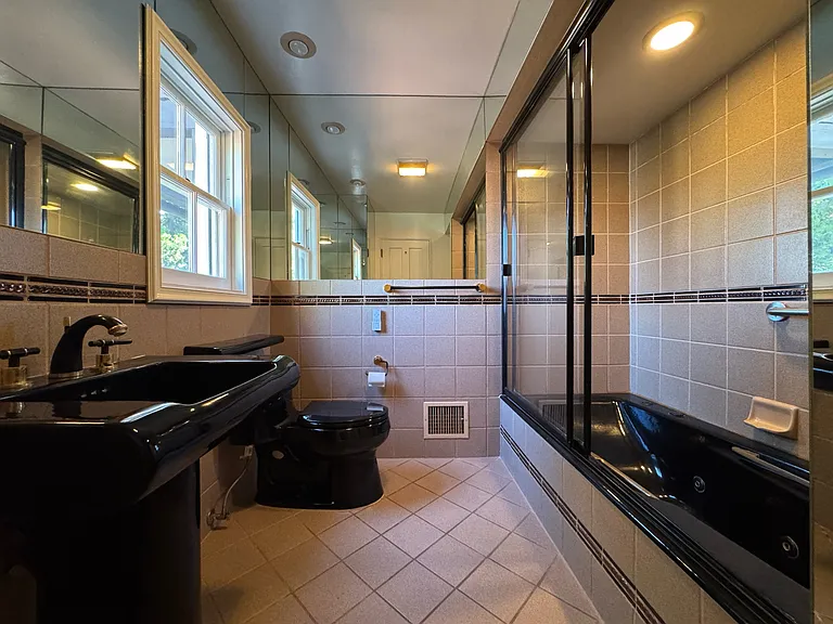 2nd-floor full bathroom - tub/shower combo with glass enclosure and pedestal sink.