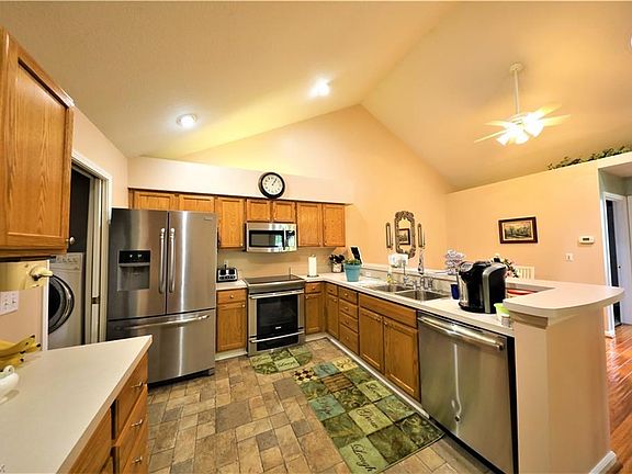 kitchen has extra cabinets & new floor & new appliances