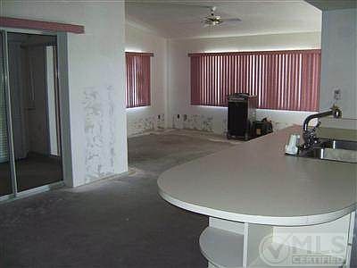 View of the living and dinning area from the kitchen. $10,000 from seller contribution will be for painting, flooring, and bathroom repairs.