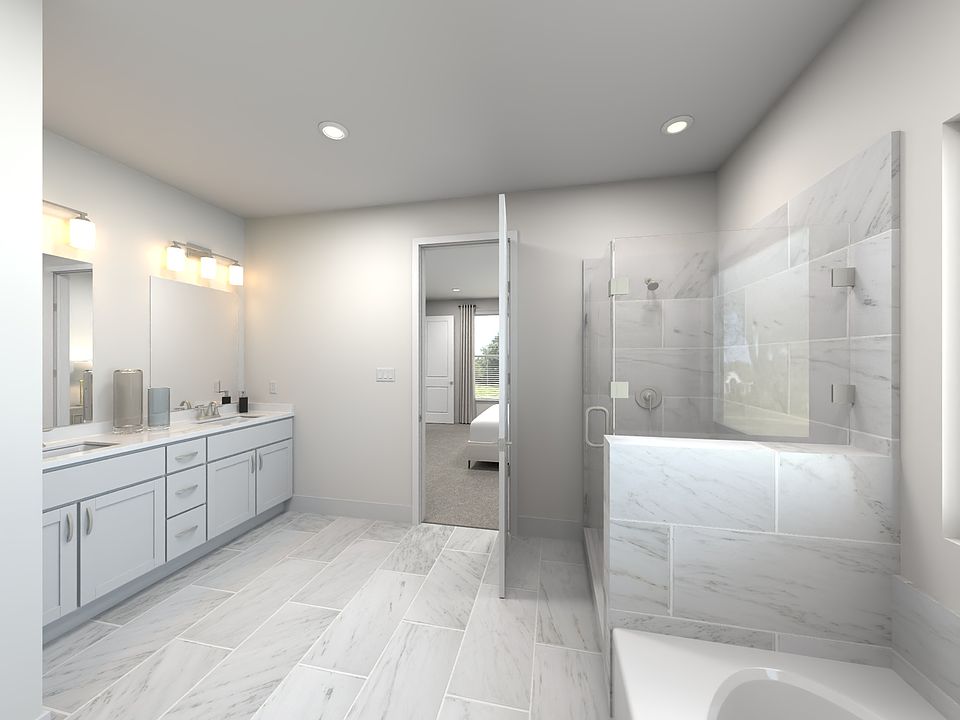 The primary bathroom offers dual vanity sinks and a walk-in shower.