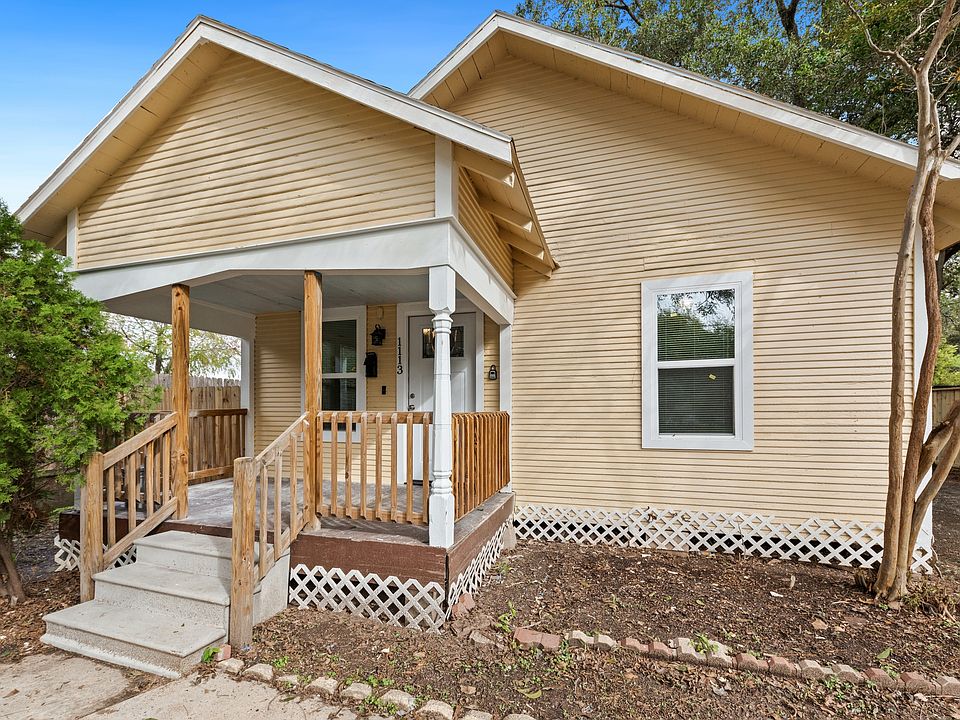 Nice porch, developed trees, fence, and painted home. Nice unique architecture