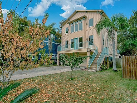 A view along the side of the home showing the great tropical plants surrounding the home and wonderful space between you and your neighbor.