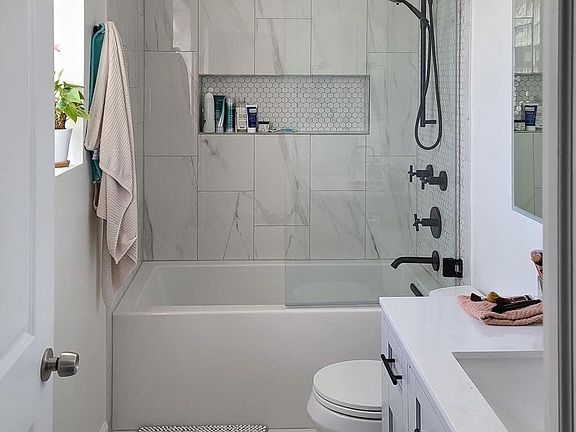 Primary bathroom with oversize soaking tub and lighted medicine cabinet.