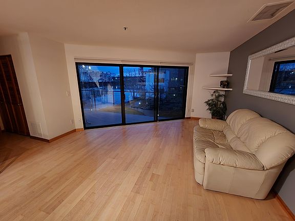 Living room with river view, slider to main deck.