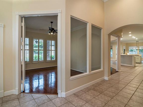 Study has plantation shutters on the windows facing the side patio. Fixed glass to the foyer makes the room open and light.