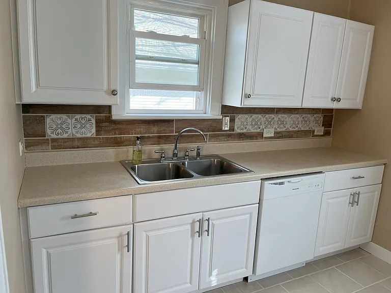 New cabinets and tile backsplash with lots of natural light!