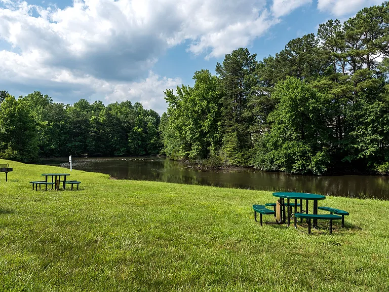 Park area with pond and picnic tables