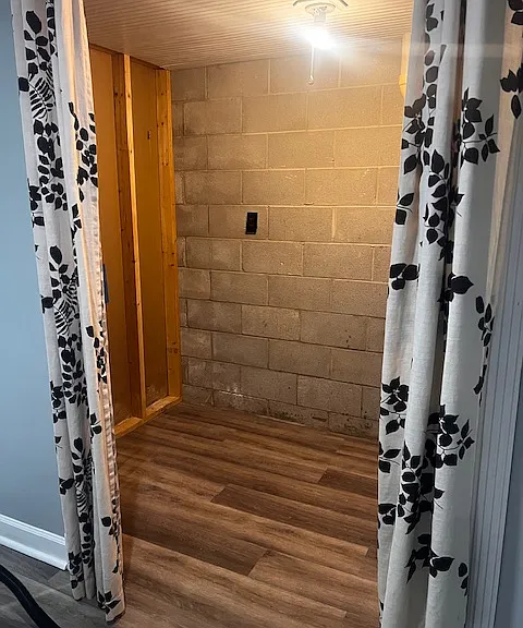 Interior of walk-in closet in basement (curtained doorway)