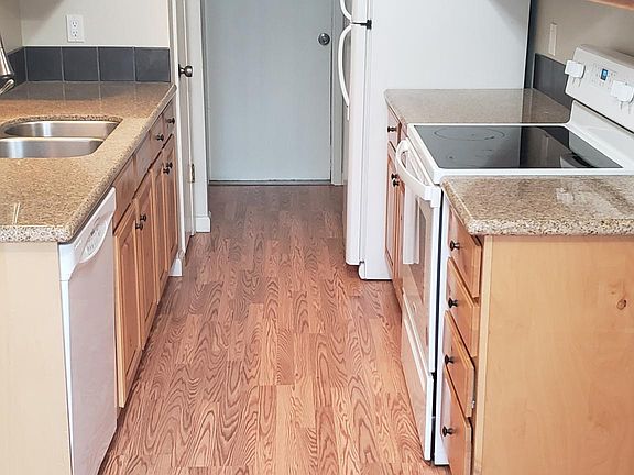 Kitchen with door into garage at the far end