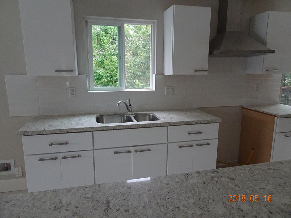 Looking straight from island.  New gas range installs to the