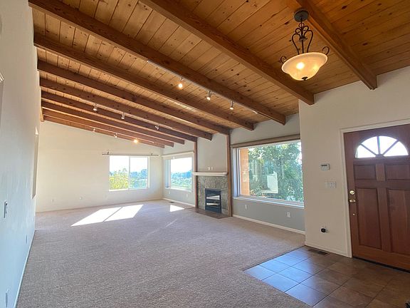 Entry and spacious living room, large double pane bay windows with multi-bridge view.