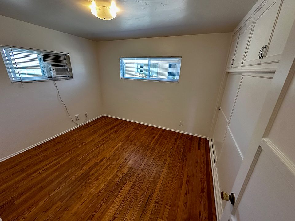 Spacious back bedroom with large closets + window AC.