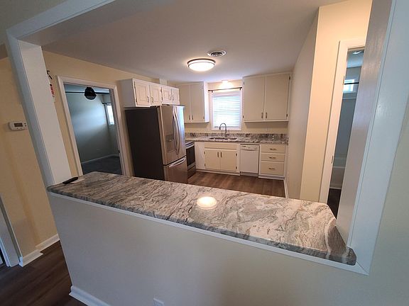 View of Kitchen from Living Room area. Island separate Living Room from Kitchen